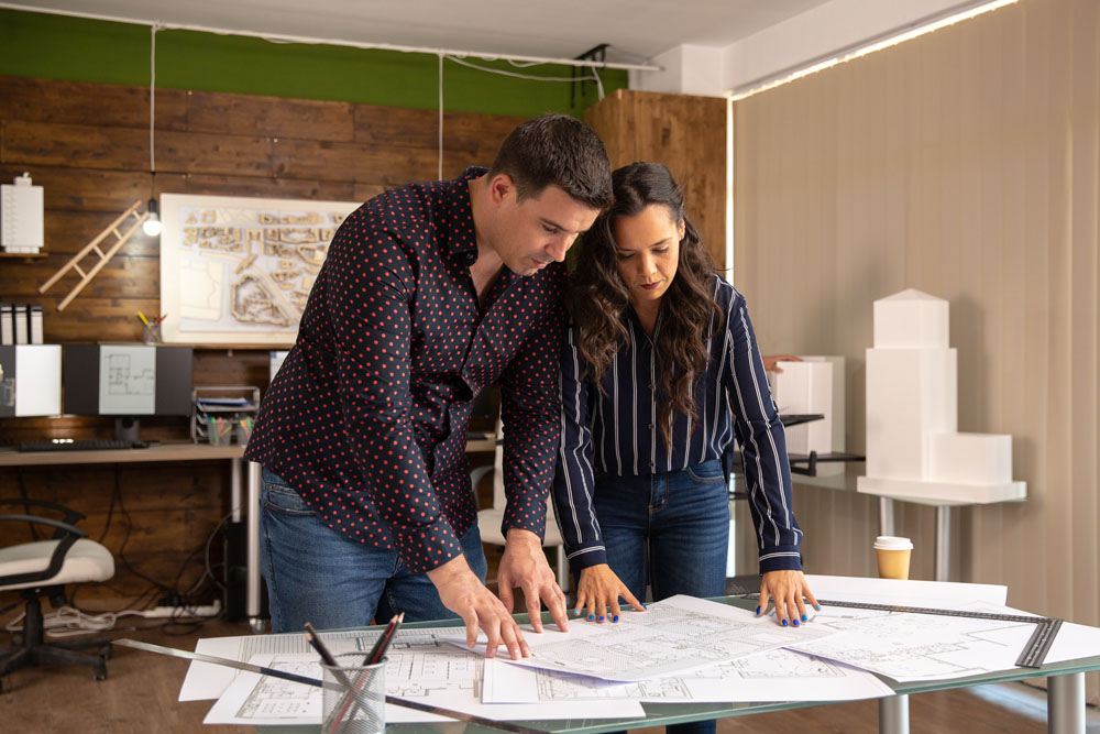 Two colleagues architect discuss some changes in the project . Modern office